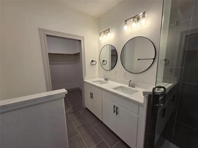 a bathroom with a double vanity sink and a mirror