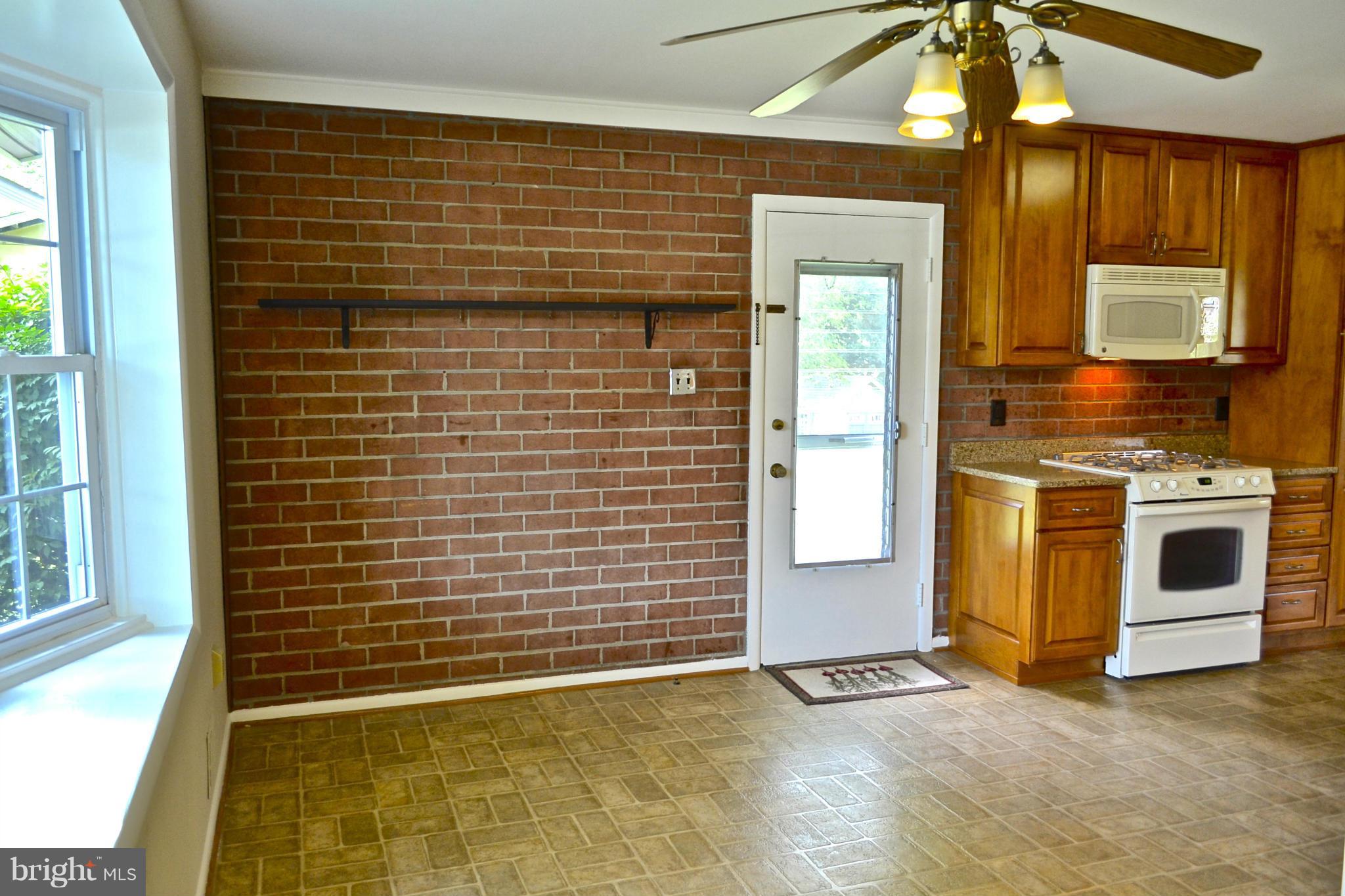 11607 Amherst Avenue Silver Spring, MD 20902 - Photo 4 of 30 Beautiful brick wall in kitchen eating space