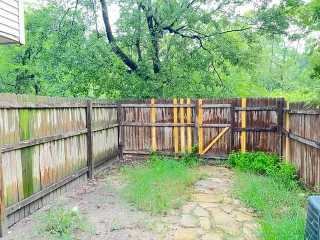 a view of a fence with a small yard
