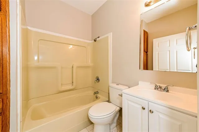 a bathroom with a sink a toilet and a large mirror