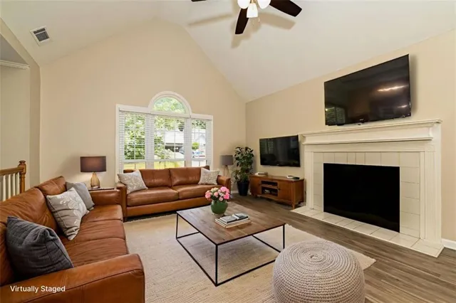 a living room with furniture a flat screen tv and a fireplace