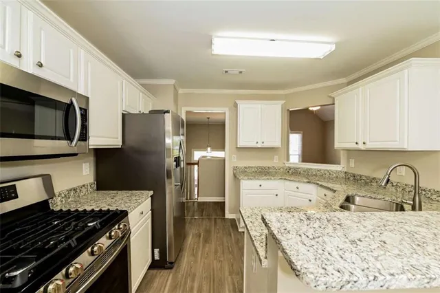 a kitchen with a sink stove and refrigerator