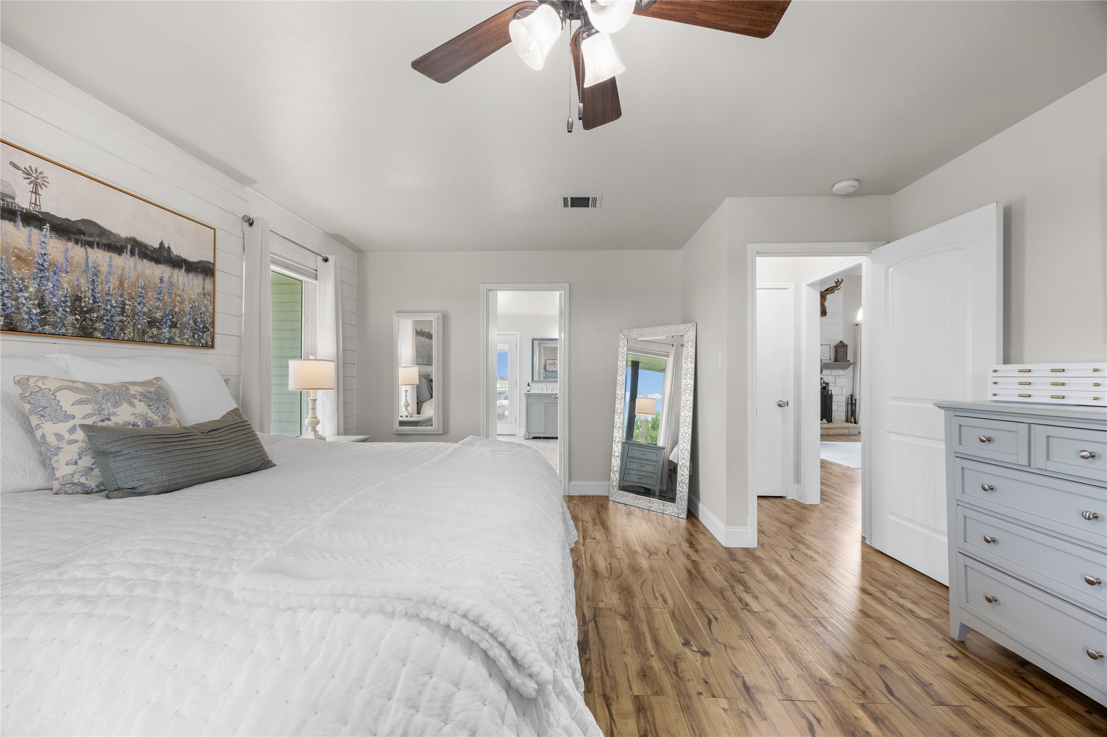 1283 Rattlesnake Trail Burnet, TX 78611 - Photo 23 of 39 a spacious bedroom with a large bed and ceiling fan