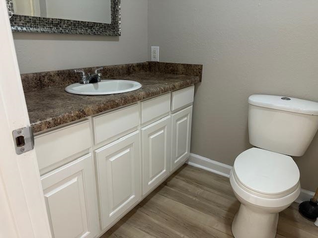 15 Brookwood Loop Adamsville, TN 38310 - Photo 8 of 21 a bathroom with a granite countertop toilet sink and mirror