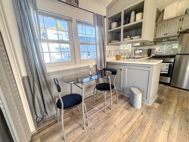 a kitchen with stainless steel appliances a stove a sink and a refrigerator