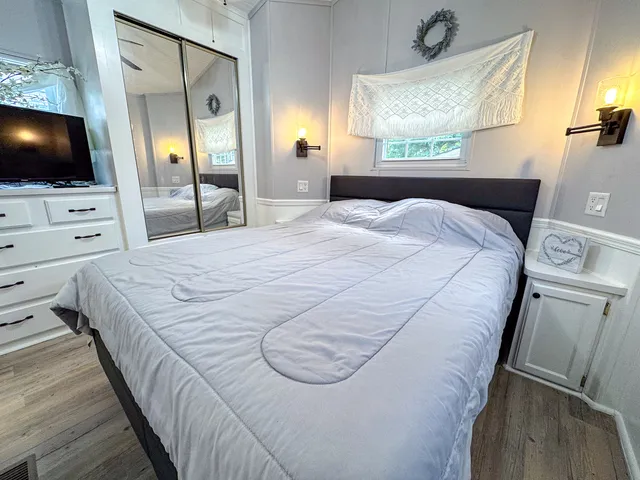 a bedroom with a bed and a flat screen tv