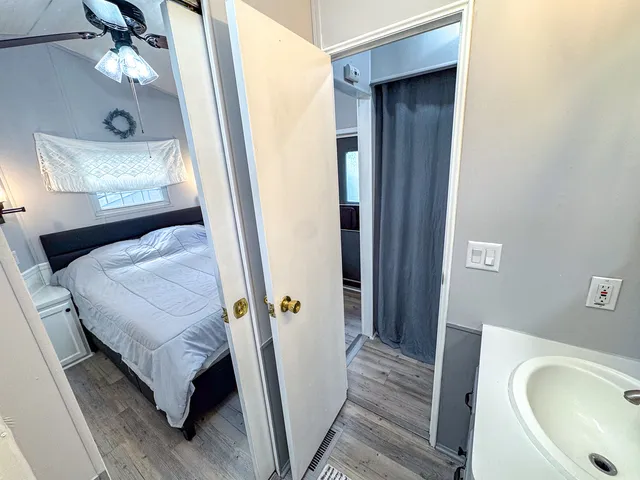 a en suite bathroom with a sink and mirror with bathtub