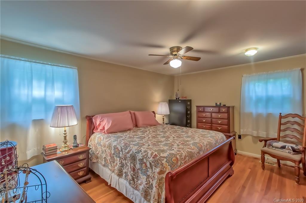 367 Potter Road Lancaster, SC 29720 - Photo 12 of 30 a bedroom with a bed and a chandelier