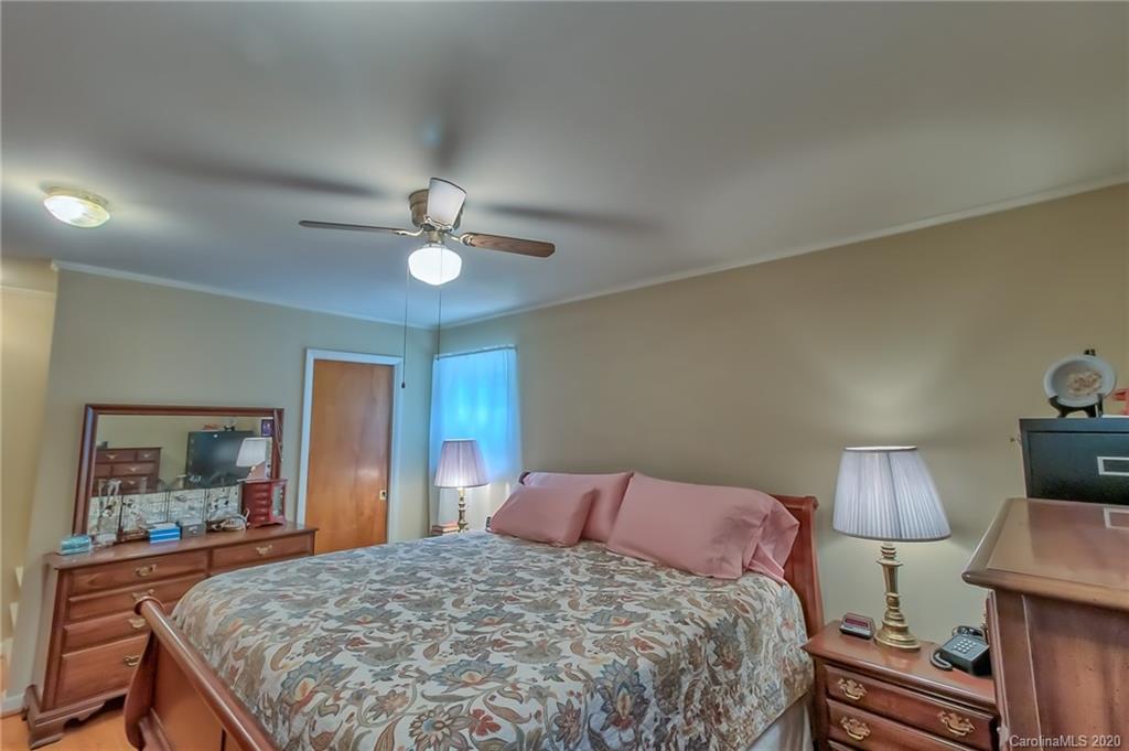 367 Potter Road Lancaster, SC 29720 - Photo 13 of 30 a bedroom with a bed and a lamp on table