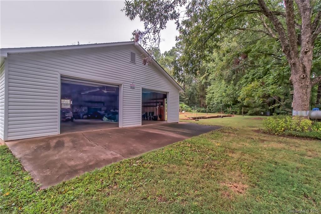 367 Potter Road Lancaster, SC 29720 - Photo 21 of 30 a view of yellow house with yard and a tree