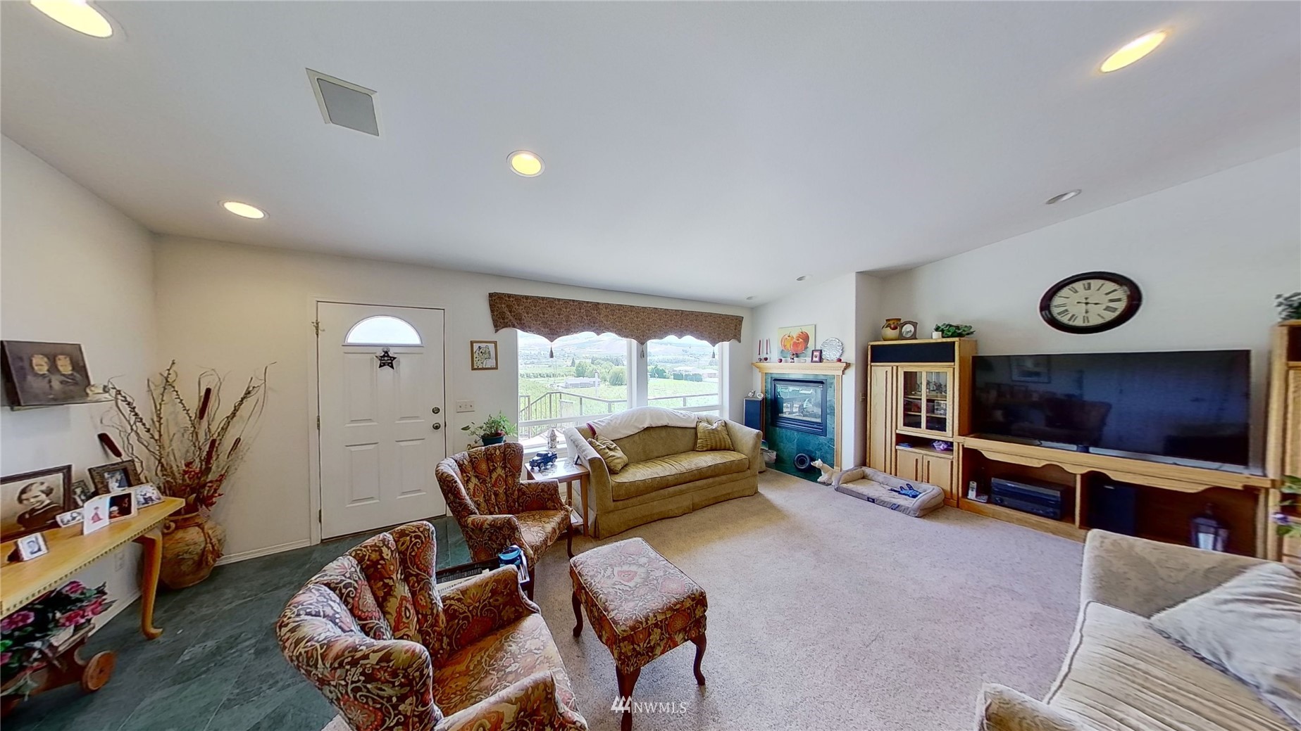 2855 Rock Island Road East Wenatchee, WA 98802 - Photo 8 of 30 a living room with furniture a flat screen tv and a floor to ceiling window