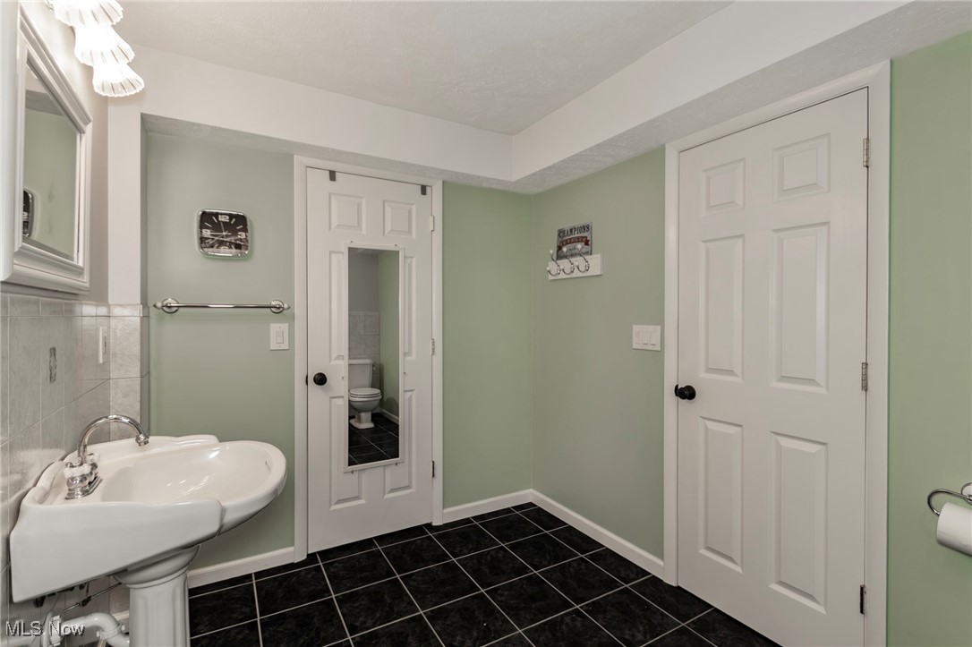 4815 South Ridge Road Perry, OH 44081 - Photo 36 of 48 Bathroom with dark tile patterned flooring and toilet