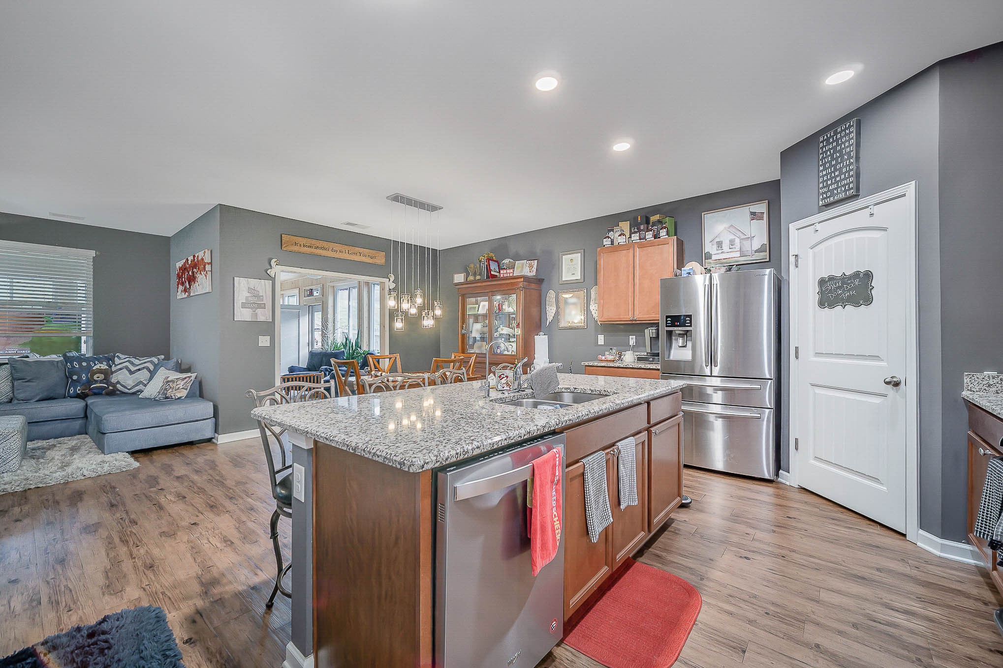 619 Prominence Road Columbia, TN 38401 - Photo 10 of 19 a kitchen with stainless steel appliances granite countertop a stove a refrigerator a sink and white cabinets with wooden floor