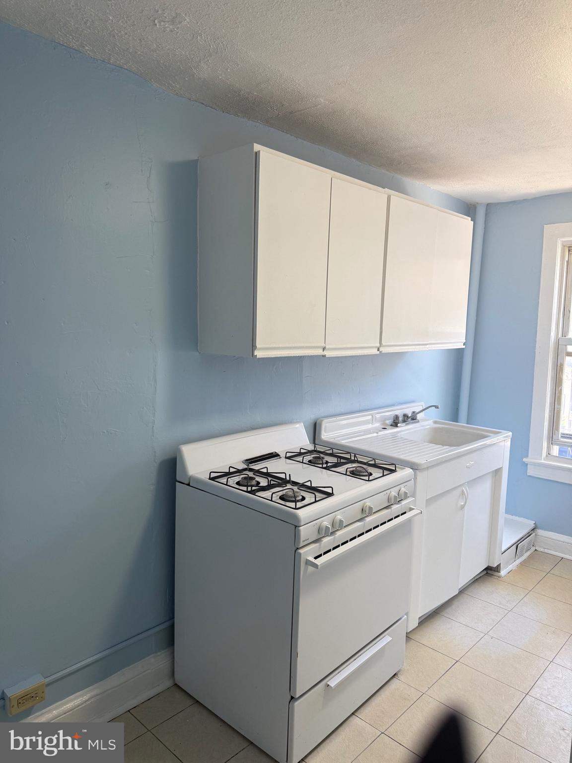203 Genesee Street, Unit 2 Trenton, NJ 08611 - Photo 5 of 5 a white stove top oven sitting inside of a kitchen