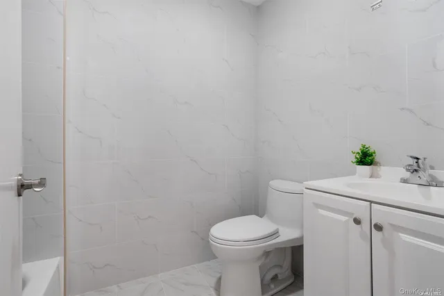 a bathroom with a sink toilet and vanity