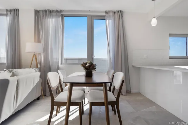 a dining room with furniture and window