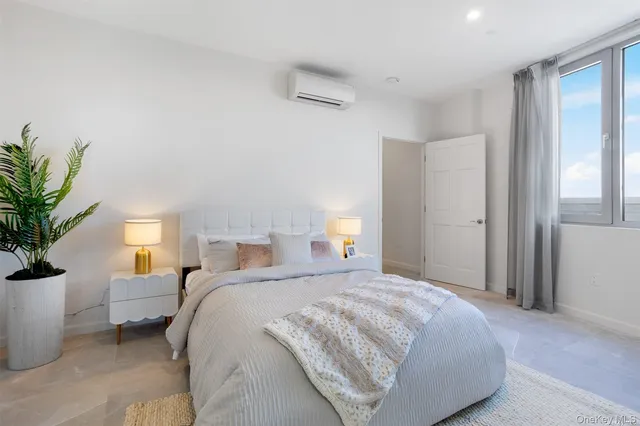 a bedroom with a bed and a potted plant