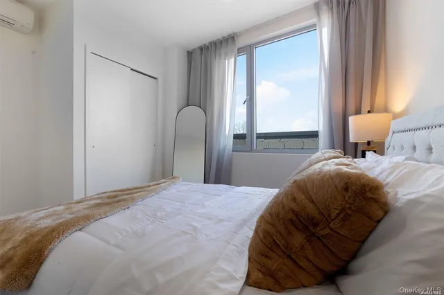 a bedroom with a bed and window