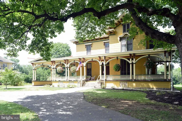 a view of a house with yard and a tree