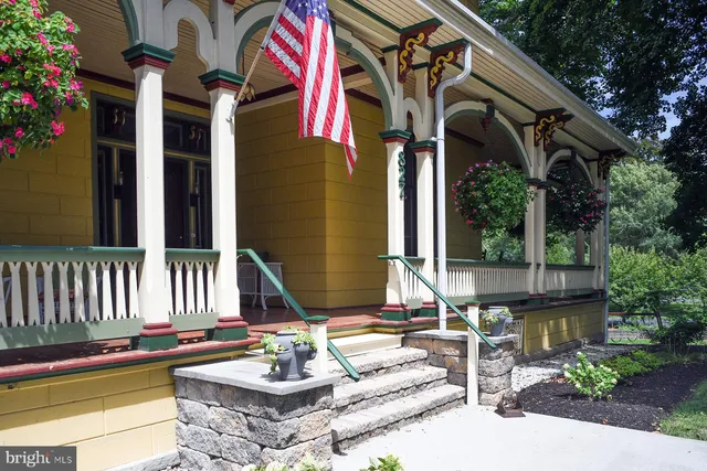 a view of house with a large windows and a table and chairs