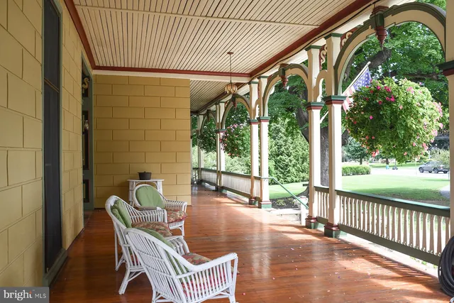 a view of a hallway with couches and dinning table