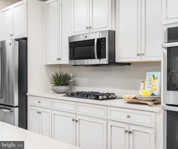 2691 Velocity Road Herndon, VA 20171 - Photo 5 of 15 Sleek modern kitchen with elegant cabinetry.