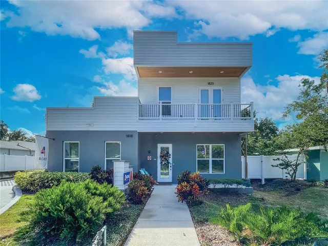 front view of a house with potted plants