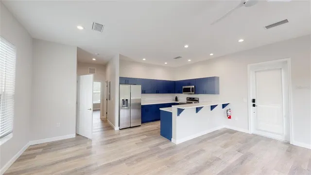 a kitchen with stainless steel appliances a stove refrigerator sink and microwave