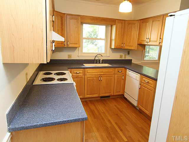5521 Mapleridge Road Raleigh, NC 27609 - Photo 10 of 24 a kitchen with stainless steel appliances granite countertop a sink stove and refrigerator