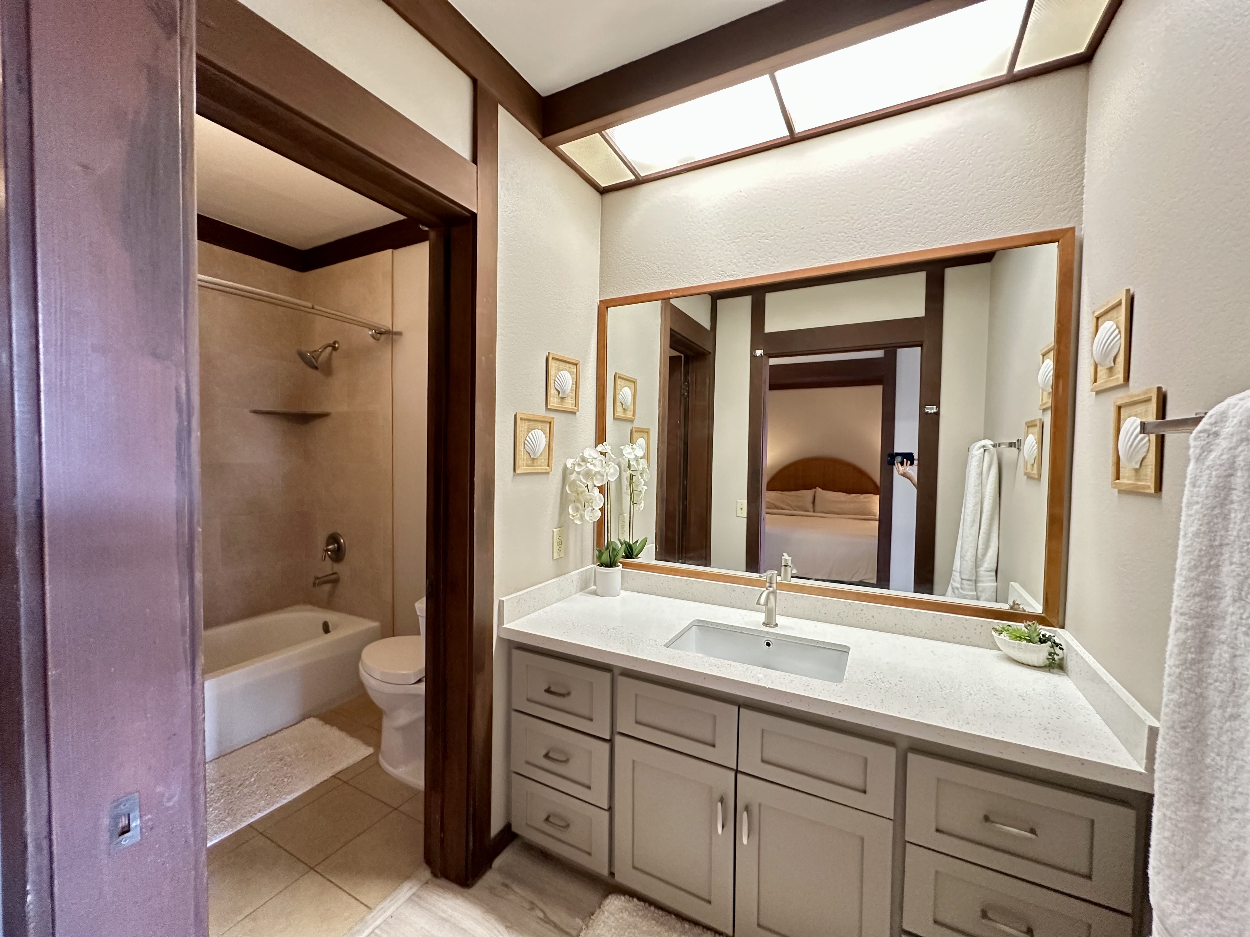 2253 Poipu Road, Unit 91 Koloa, HI 96756 - Photo 11 of 14 a bathroom with a double vanity sink and mirror with toilet