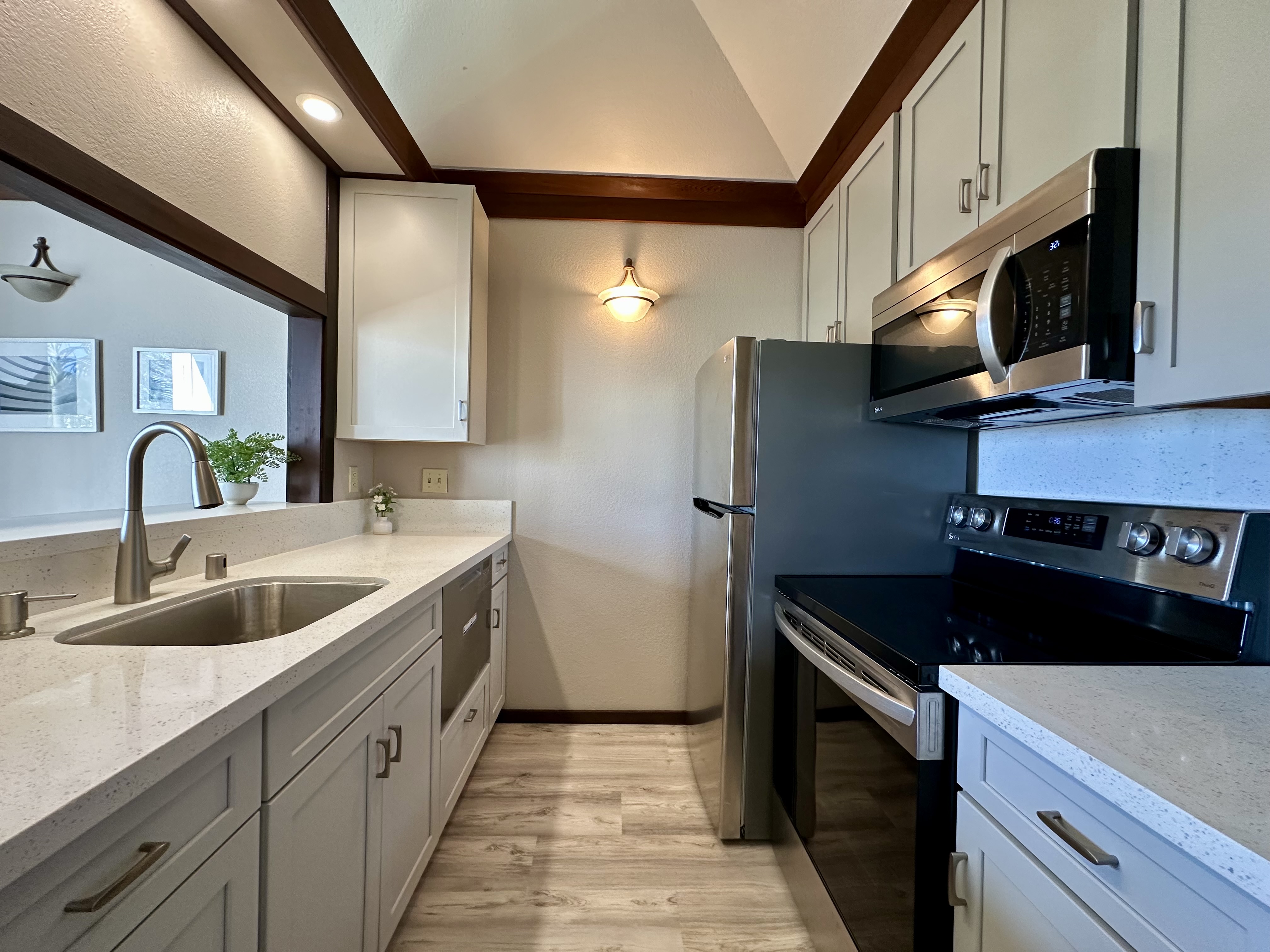 2253 Poipu Road, Unit 91 Koloa, HI 96756 - Photo 7 of 14 a kitchen with a sink and a refrigerator