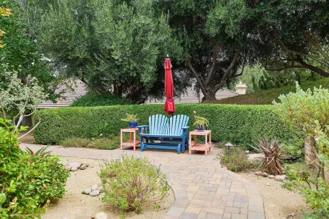 a bedroom with furniture and large windows