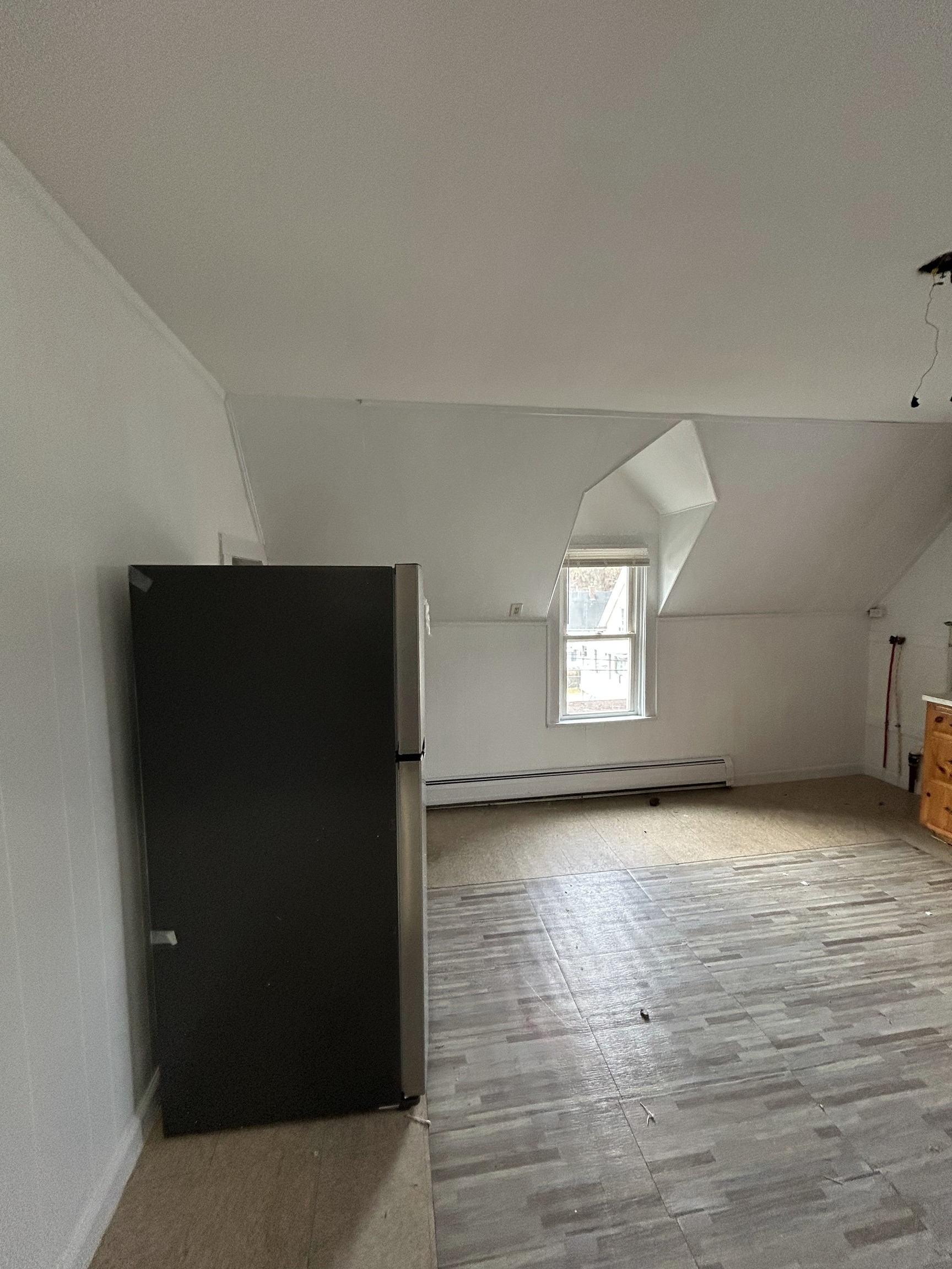 126 Boswell Avenue, Unit 2 Norwich, CT 06360 - Photo 16 of 27 a view of an empty room with wooden floor and a window