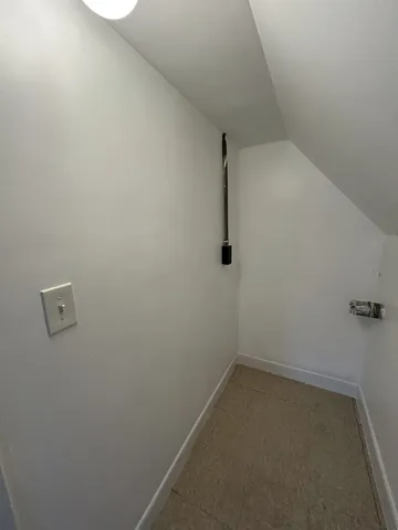 an empty room with a window and a ceiling fan