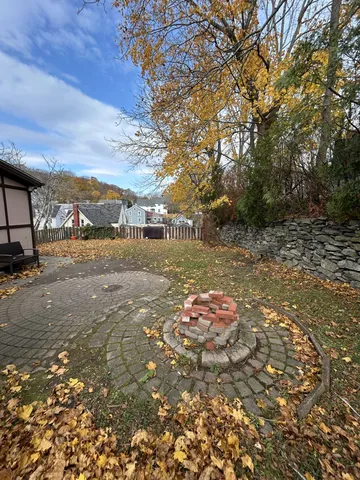 a backyard of a house with table and chairs