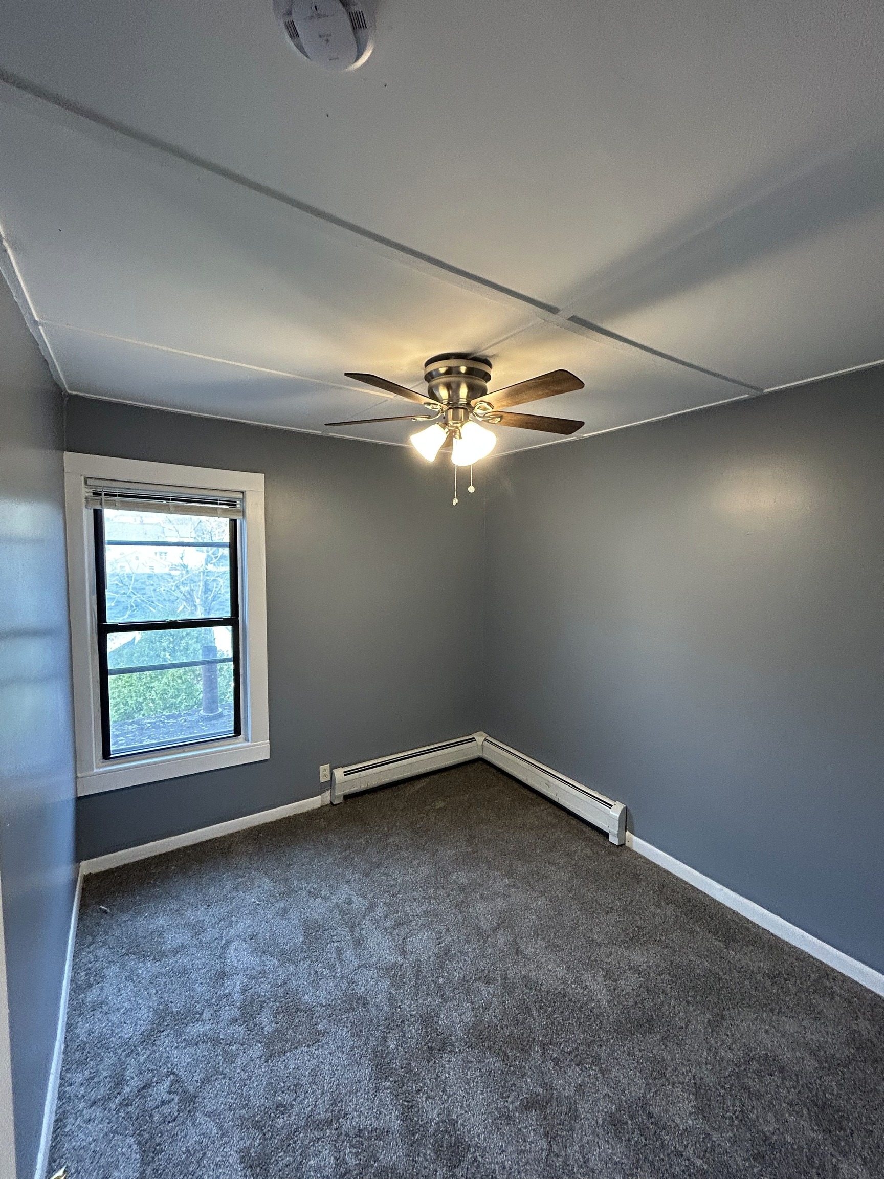 126 Boswell Avenue, Unit 2 Norwich, CT 06360 - Photo 27 of 27 an empty room with a chandelier fan and windows
