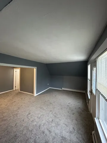 an empty room with a empty space and windows