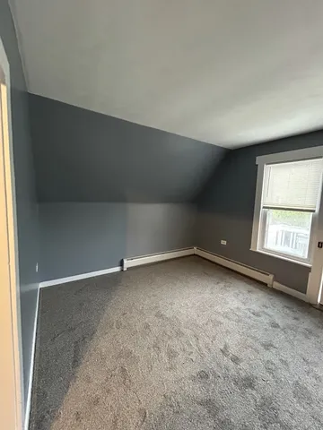 a view of a livingroom with a ceiling fan and window