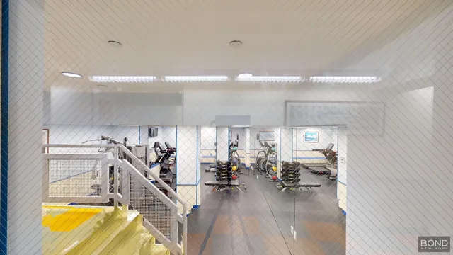 a utility room with dryer washer and a view of living room