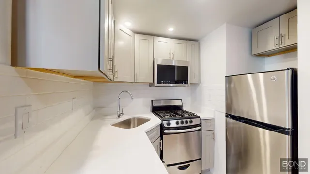 a kitchen with stainless steel appliances a refrigerator stove and microwave
