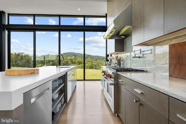 a kitchen with a stove a sink and cabinets