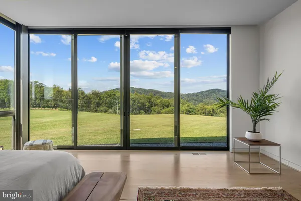 a living room with a large window and a table