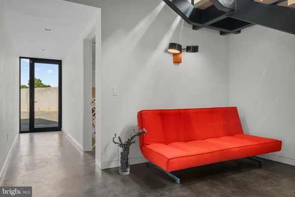 a blue couch sitting in a room next to a window