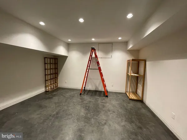 a view of an empty room with wooden & and utility room