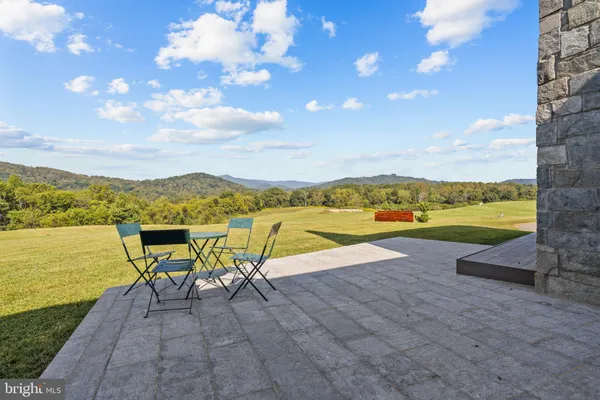 a view of a swimming pool and an outdoor seating