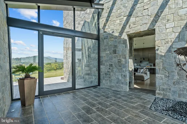 a bathroom with a glass door shower and a sink
