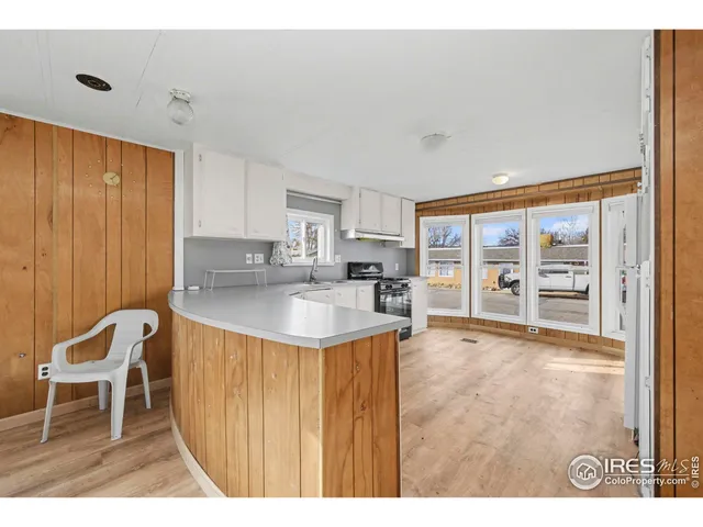a kitchen with a table chairs and a refrigerator