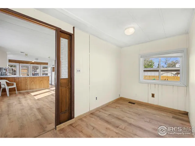 a view of empty room with wooden floor
