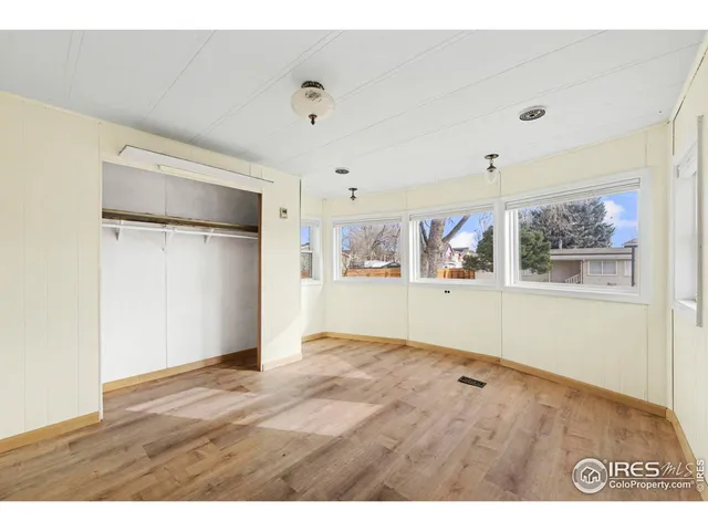 a view of a kitchen with wooden floor and a cabinet