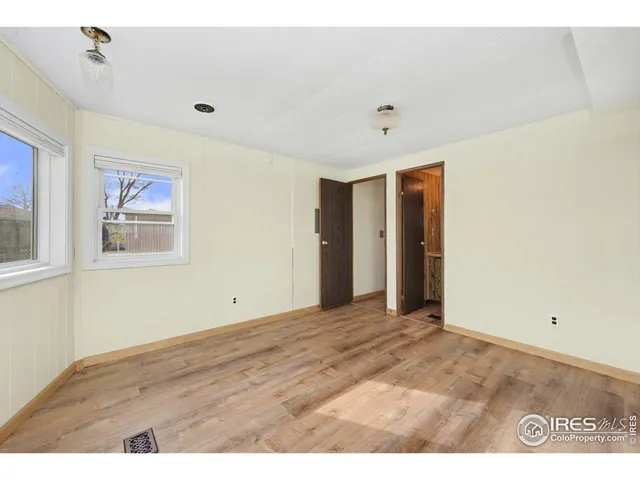 a view of an empty room with wooden floor